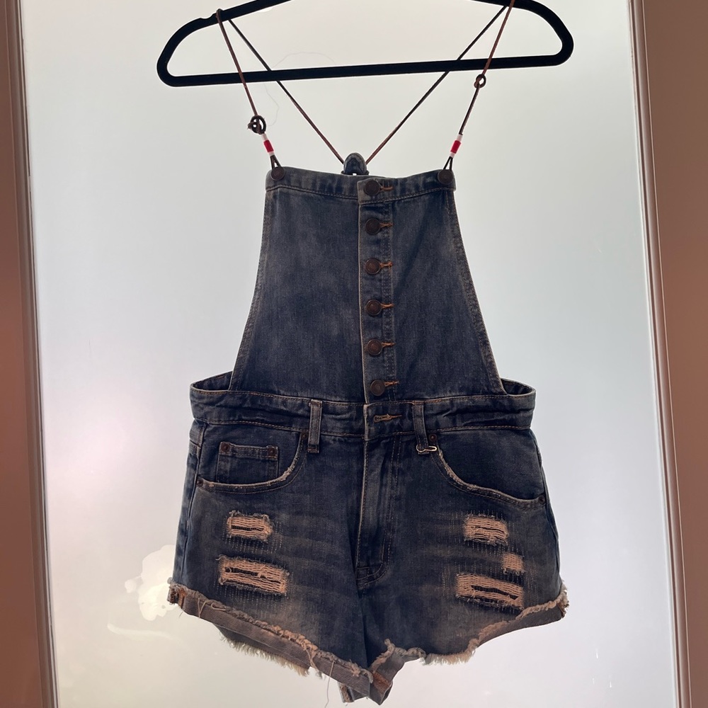 Dark distressed denim overalls